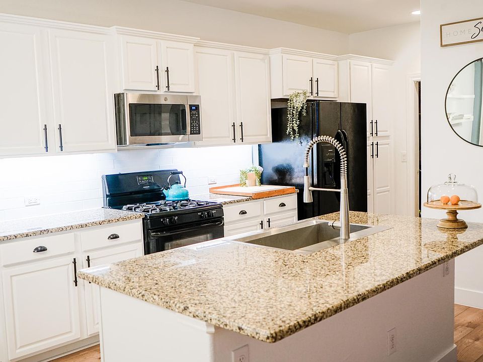 Renovated kitchen with bright, white cabinets, matte black and stainless steel appliances, & XL 33 inches wide farm sink!