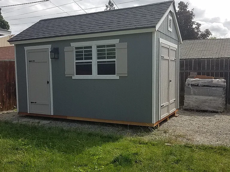 New 14 x 8 garden tool shed next to garage