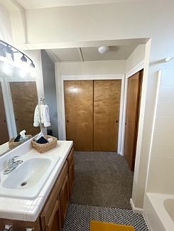 Master bathroom facing double closets.