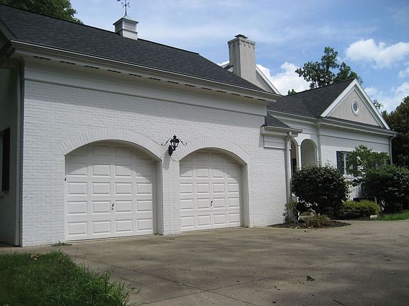 Circular drive in front, garages w/ turn-around on side
