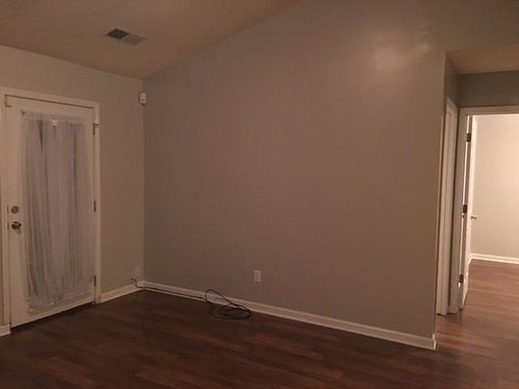 Living room facing the side door and back wall
