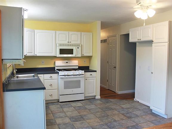 Newer, updated kitchen features tile floor, gas convection stove, and pantry cabinet.