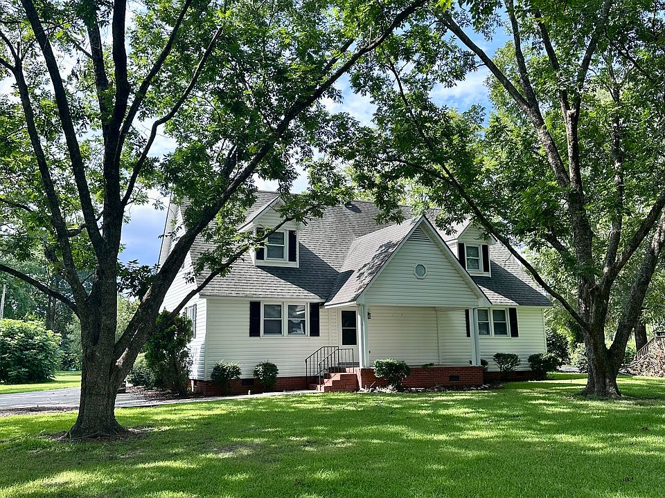 Pecan trees in the shaded front yard, with a porch perfect for rocking chairs and enjoying the outdoors!