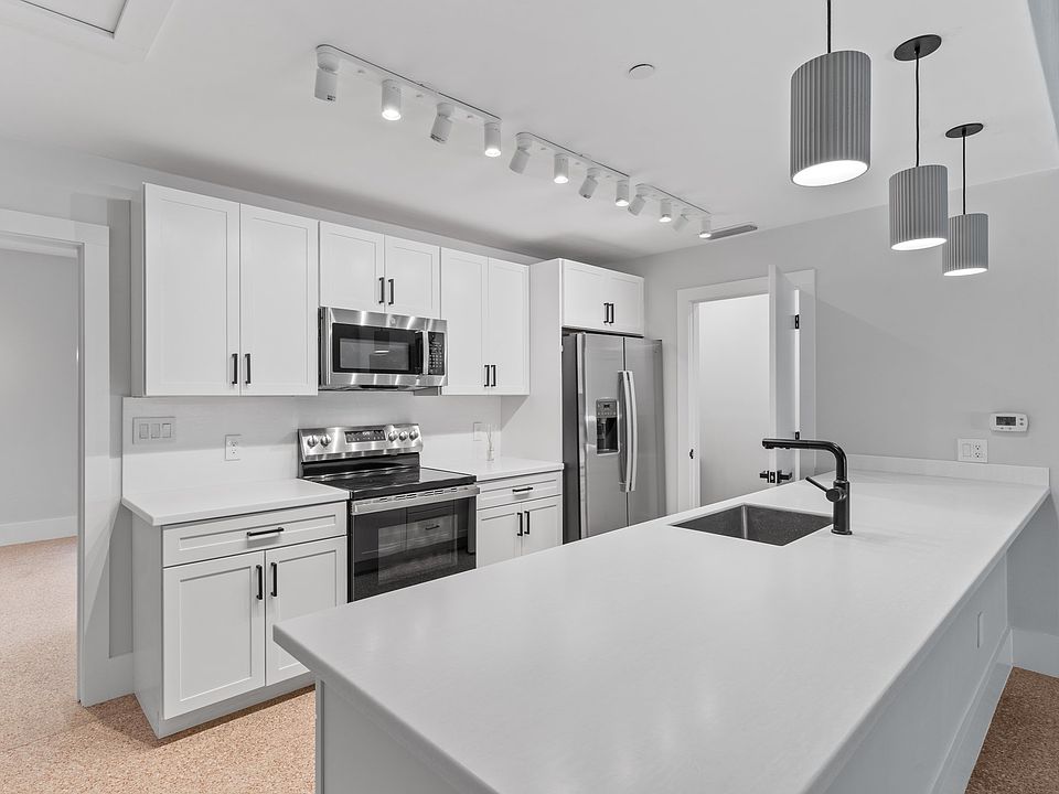 The kitchen is bright and inviting and reflects a minimalist beauty.