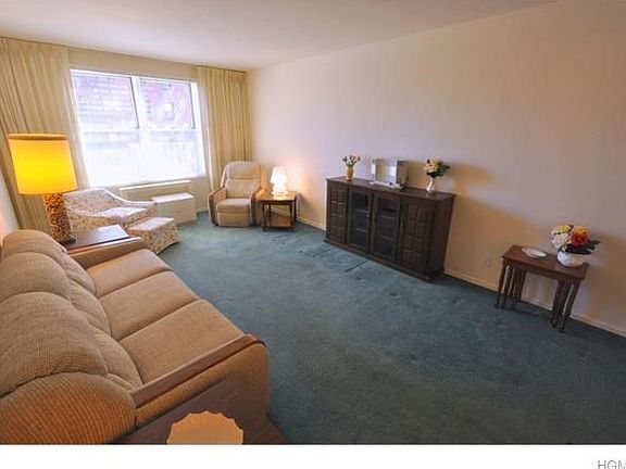 Bright and Sunny living room opens to the dining area. The room has covered hardwood floors.