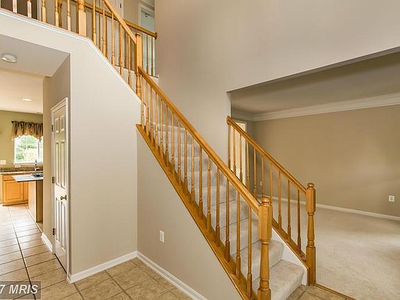 Front entry foyer view to stairs/living room