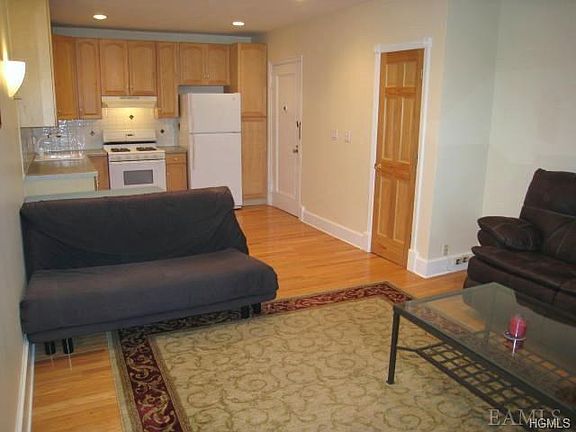 Open Living Room with hardwood floors. Room is 18' x 13' plus kitchen that is 11'- x 7'