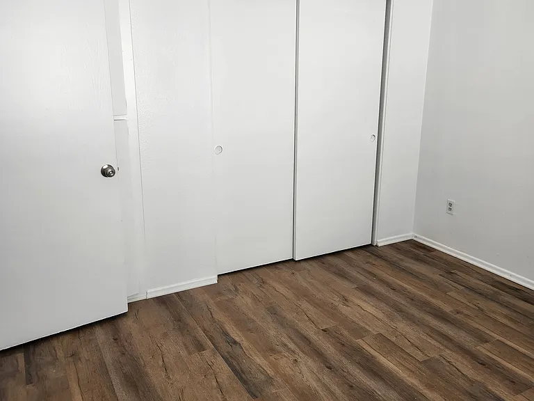 Bedroom #2 with closets. not in photo opposite the closet is a wall with a window.