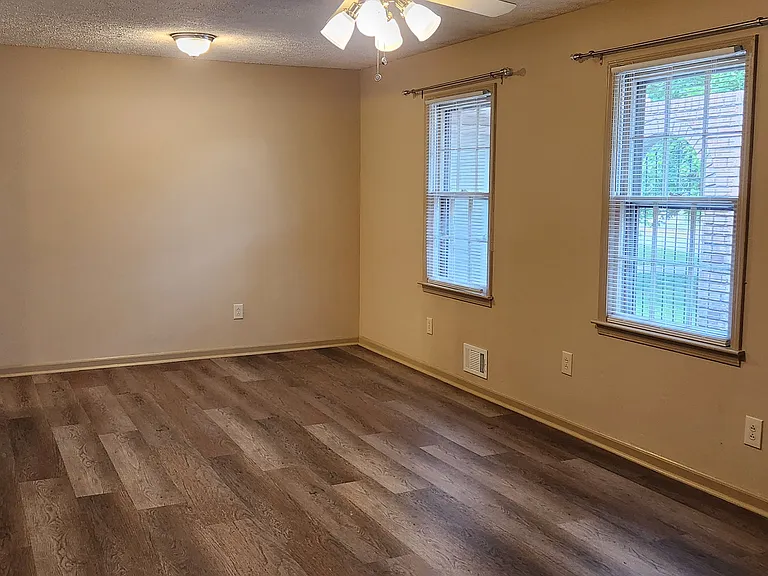 Living room with wall-mounted TV bracket ready for your TV.