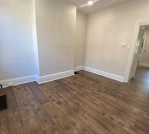 Freshly painted living room with new lighting and flooring