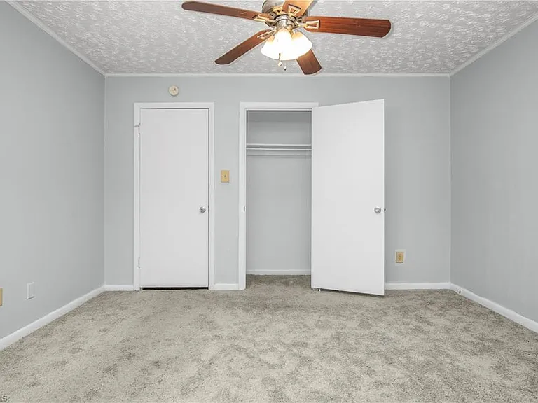 Primary Bedroom (looking at closet, 1 of 2) and door into hallway