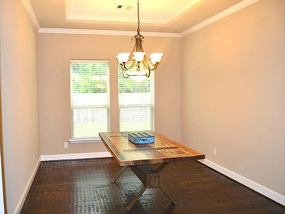 The dining room with its trey ceiling, polished bronze chandelier and great view of the private side