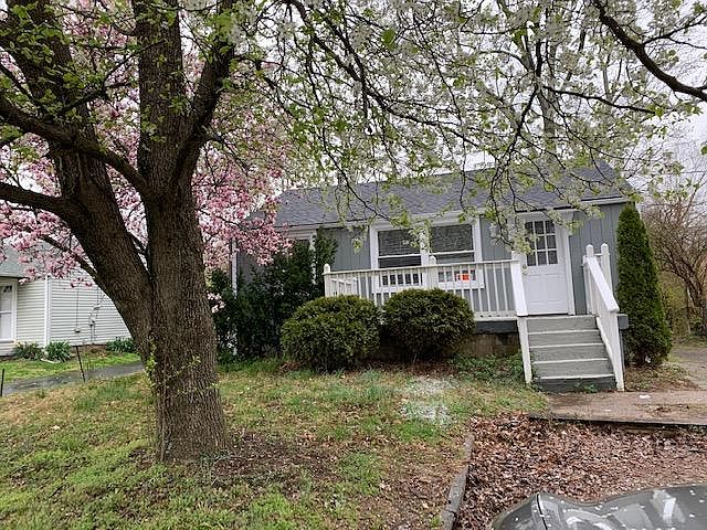 Front of the house facing Evergreen rd. with a porch.