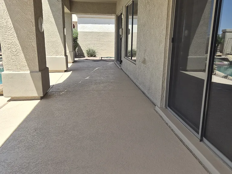 Large covered patio in backyard with entry from both the living room and master bedroom