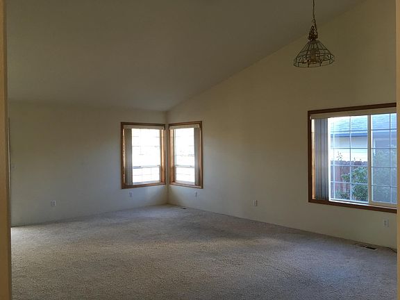 Open living/dining room with vaulted ceilings
