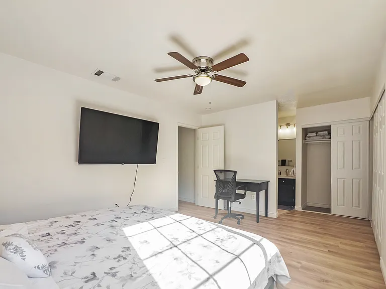 Bedroom # 1 with a king bed, work station, smart TV, and en suite full bathroom