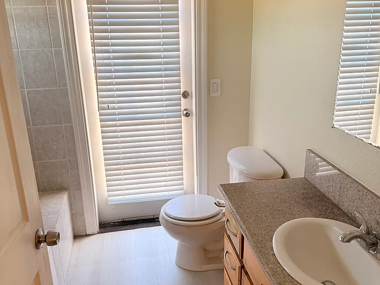 Ensuite bathroom with a door leading to a balcony
