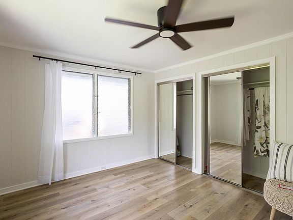 One of the three rooms; all have ceiling fans and mirror closet doors