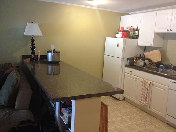 Kitchen bar has bookshelves/storage underneath