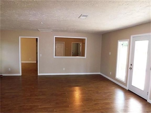 Family room view towards kitchen with breakfast bar and open area