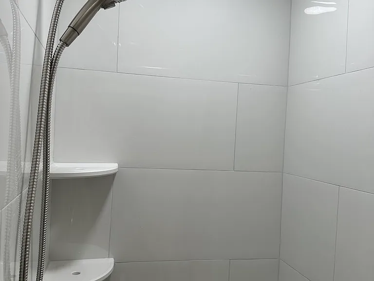 Brand new tile and fixtures in primary shower.