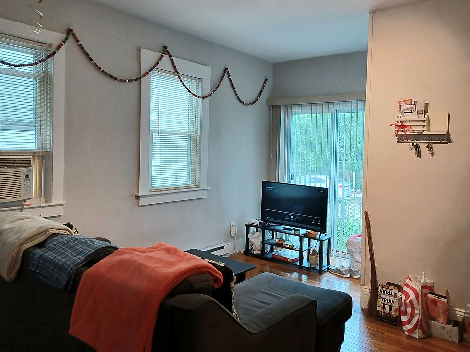 Living room with sliding door to small brick patio.
