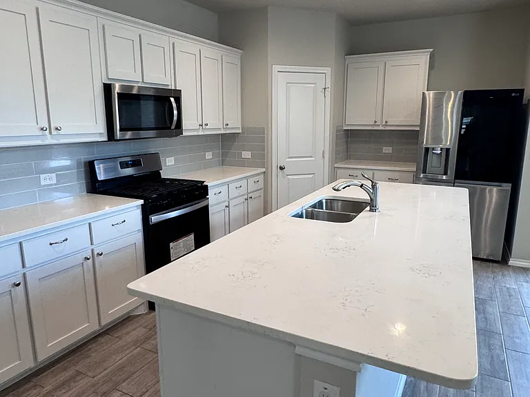 Large Kitchen island with plenty of cabinet space.