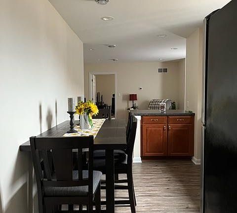 From the doorway entrance, this shows the kitchen then living area and finally the entrance into one bedroom.