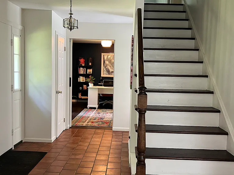Formal front Entry with view of office and staircase.