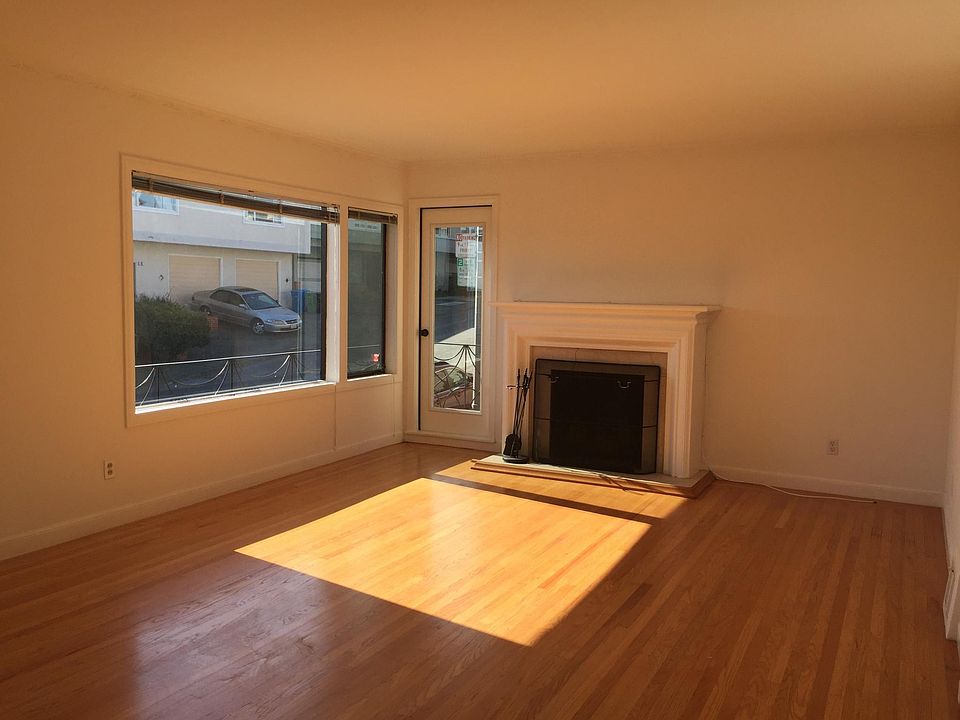 Living Room, with marble fireplace and balcony door facing g