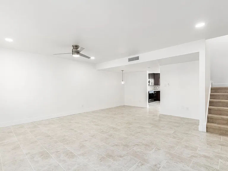 Living area with stairs leading to master bedroom