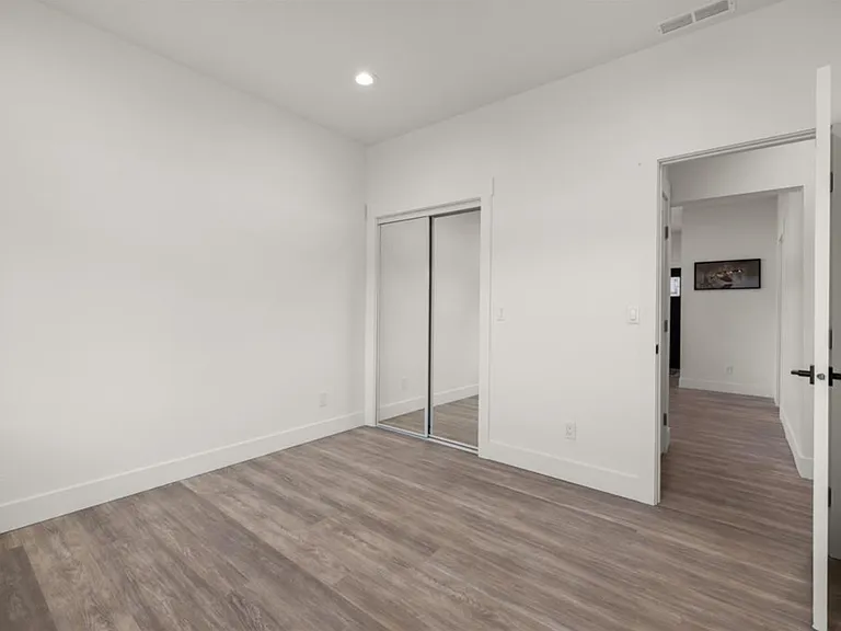 The 3rd bedroom, located on the main floor, features beautiful mountain views, a sliding mirrored-door closet, and an adjacent private bathroom with high-end finishes.