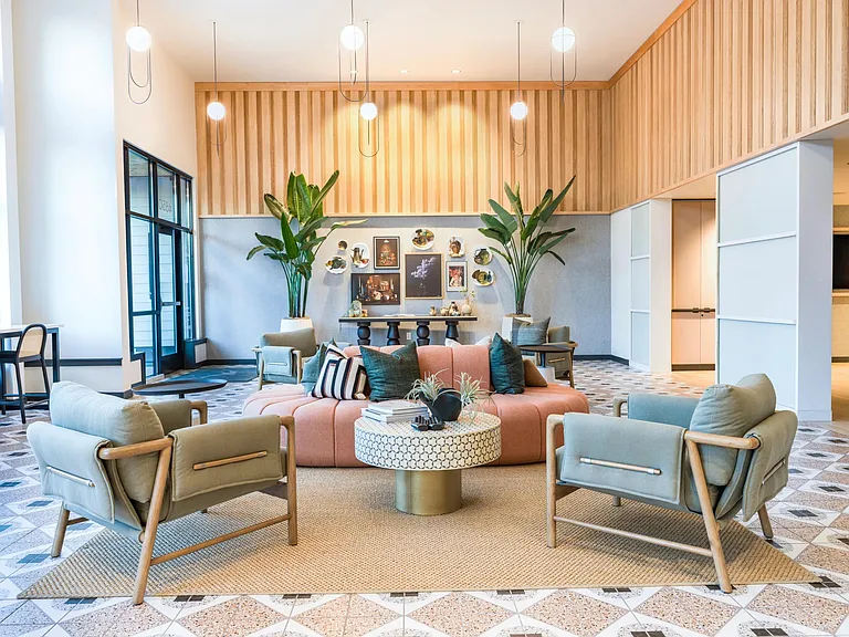 Experience the welcoming ambiance of the Modera Woodstock leasing office, featuring stylish seating and curated artwork that reflect the community's modern Portland charm.