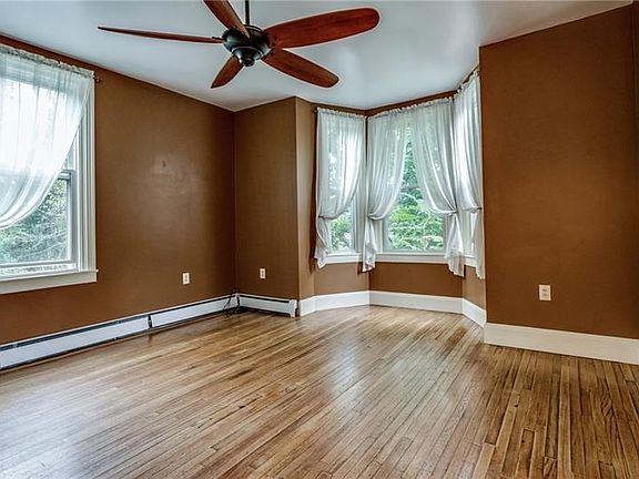 Living room, lots of natural light and look at those lovely hardwood floors!