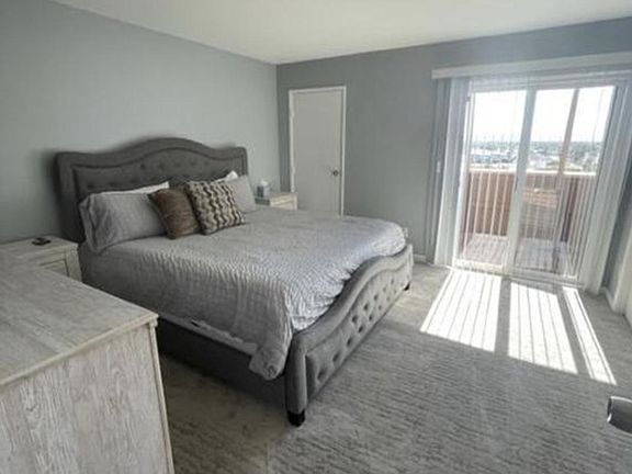 Master king bedroom with TV and wall to wall closet space.