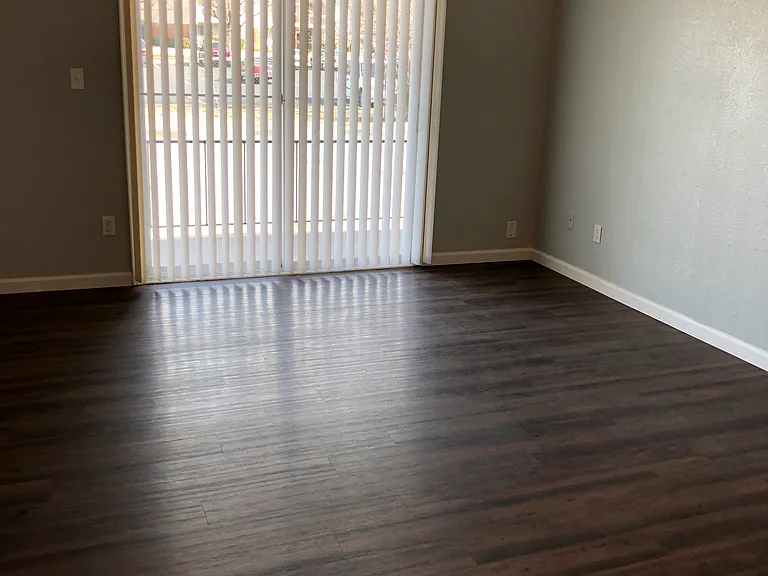 Living room of one of our 2-bedroom / 1-bathroom units that has balcony/patio