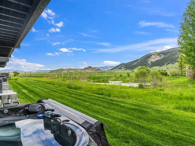 View from the hot tub to the back gardens and duckpond shared by 5 units with the National Elk Refuge and Gros Ventre Range beyond