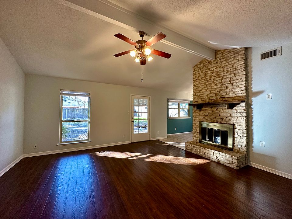 Living room with vaulted ceilings and stone fireplace