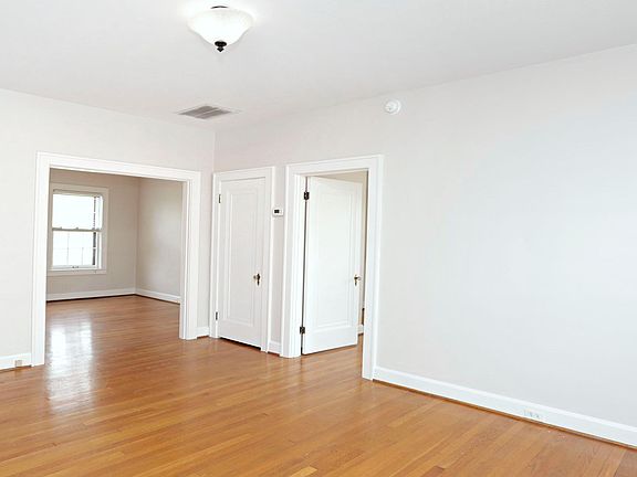 This is the living room. The open door on thr right leads into the bedroom. The closed door is a closet (& there's another closet on the opposite wall). The big opening leads onto the dining room.