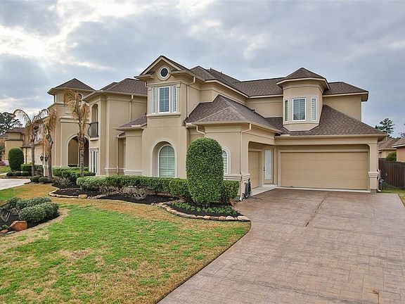 Property features secondary driveway with access to 4-car attached garage.