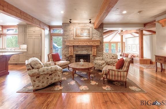 This is a charming sitting area adjacent to the kitchen with a wood burning fireplace.