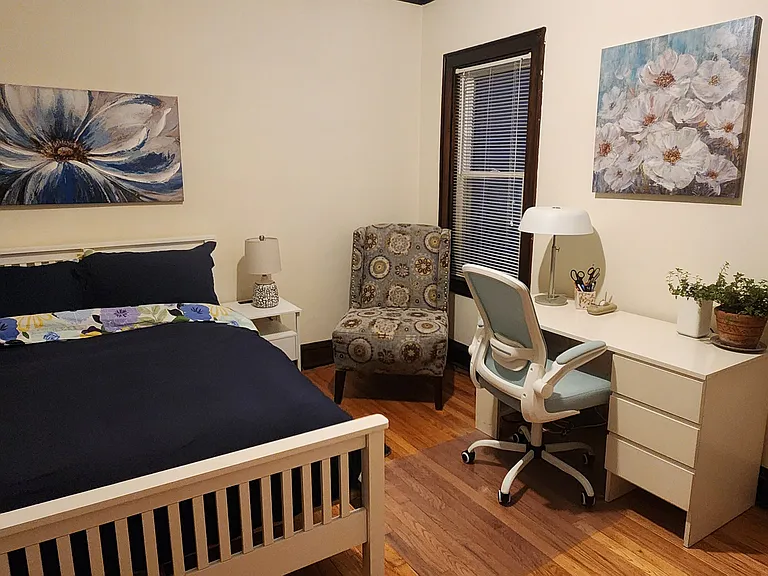 Second Bedroom with new full-sized Purple mattress bed, desk, chair, cabinet, rolling cart, nightstand, two lamps, an accent chair, rug, artwork and large closet.