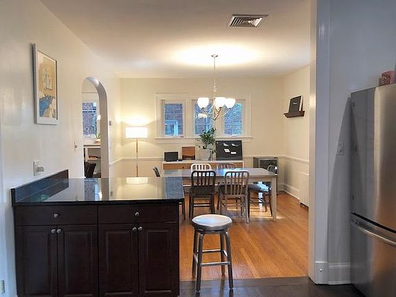 View from kitchen into dining room. Kitchen features large island with granite countertops.