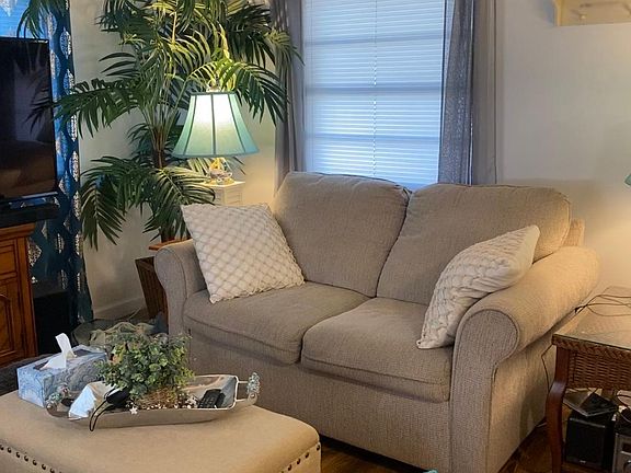 The other side of the living room With window facing the carport. ( furnishings not included - for display only )