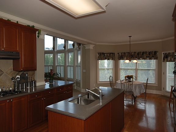 Gourmet Kitchen with Island, stainless steel appliances and hardwood floors.