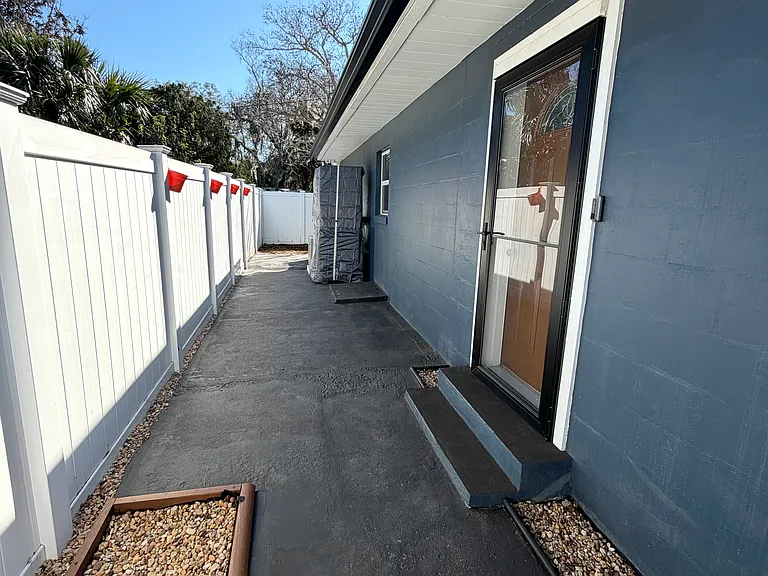 Includes a welcoming main entrance and a spacious patio area for relaxing or entertaining.