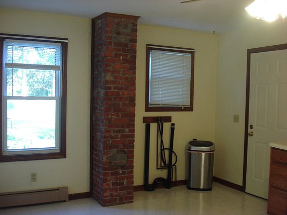 Kitchen: washer/dryer hookup, decorative exposed brick, morning sun comes in three windows