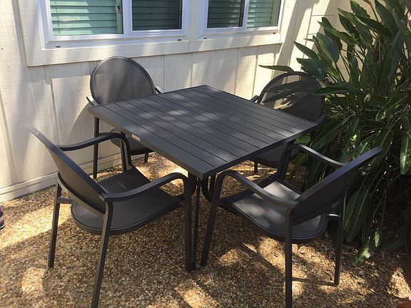 Table and chairs set in front courtyard