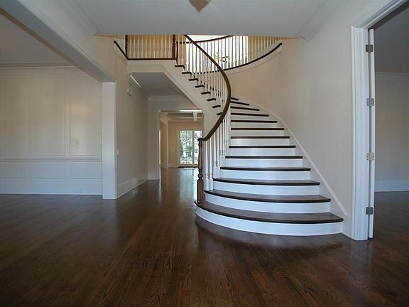 Gorgeous hardwoods and ornate winding staircase