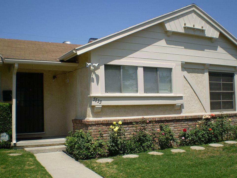 Ffront of home with tons of rose bushes